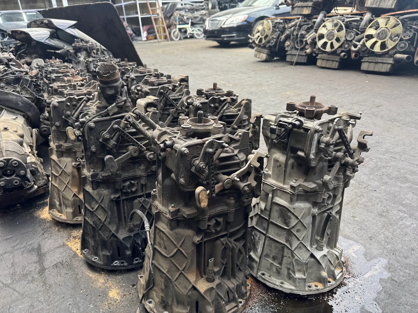 Row of salvaged gearboxes lined up in the yard